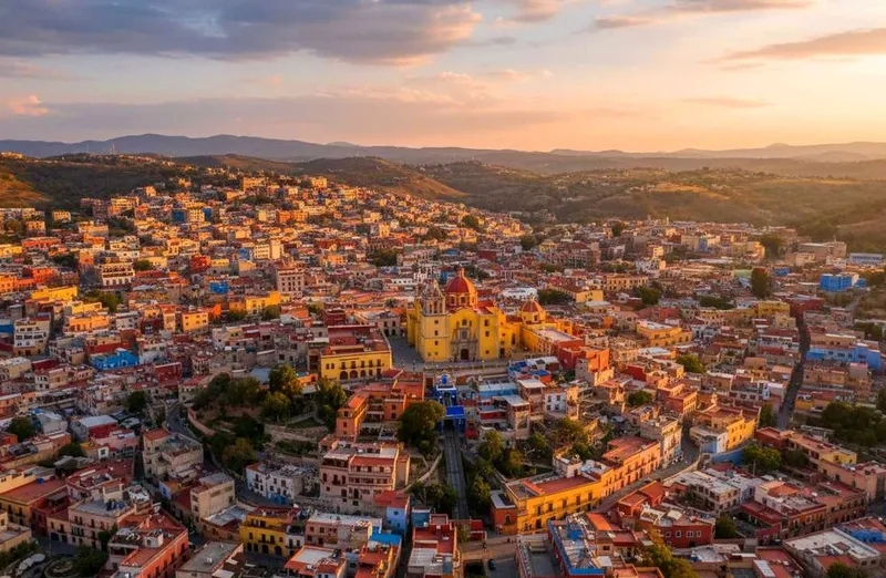 Guanajuato in September with colorful hillside houses, rainy-season greenery, and Independence Day energy