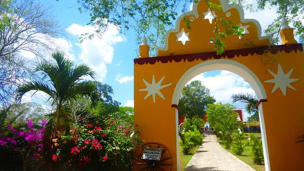 Open-air cenote at historic Hacienda Mucuyché Yucatán with colonial building in background