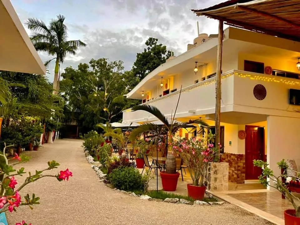 Casa Lima Bacalar courtyard garden with guest room balconies