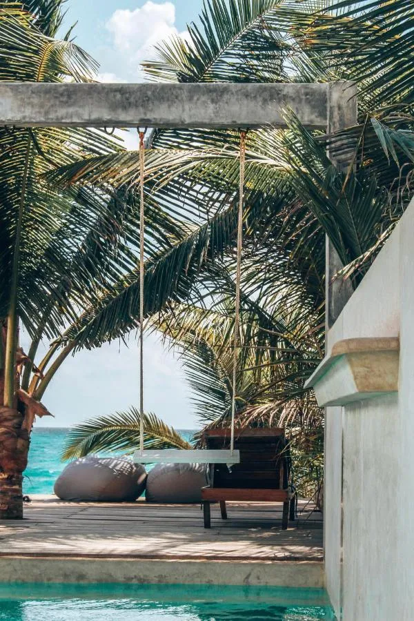 Tulum hotel courtyard with tropical plants and shaded guest-room access