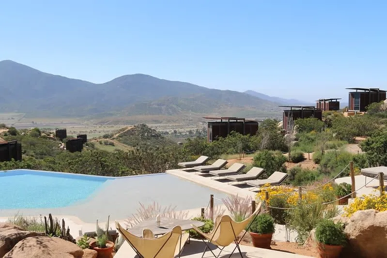 Hotel Encuentro Guadalupe cliffside rooms overlooking Valle de Guadalupe vineyards at dusk