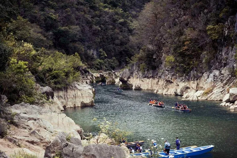Wide turquoise waterfall pool in Huasteca Potosina surrounded by dense green jungle