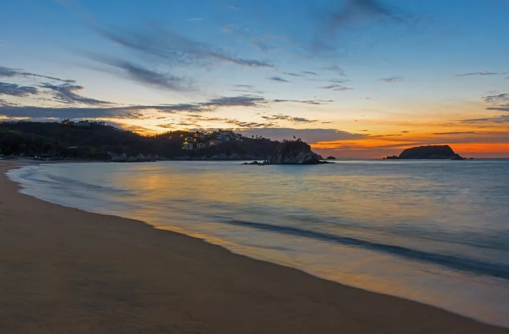 Tangolunda Bay in Huatulco with luxury resort hotels, palm trees, and the Pacific Ocean