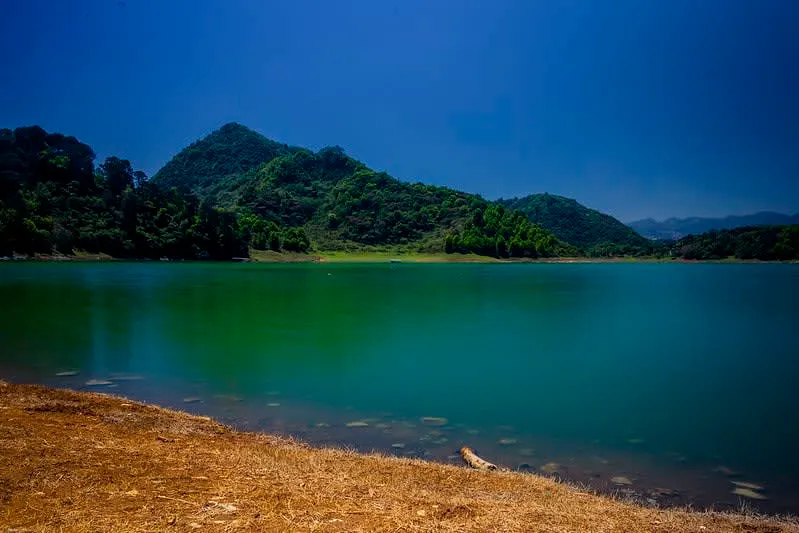 Tenango dam backed by green Sierra Norte hills