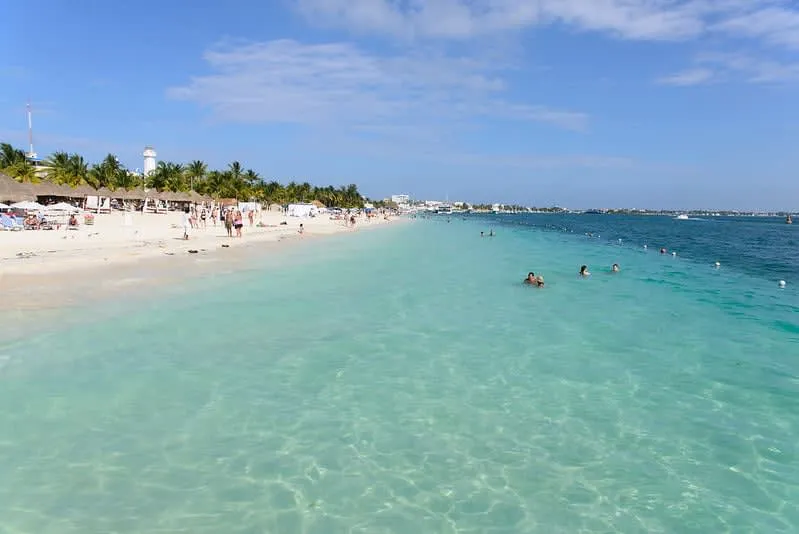 Playa Norte on Isla Mujeres with shallow turquoise water and beach umbrellas