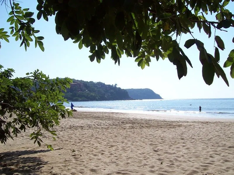 Quiet Pacific beach near Ixtapa-Zihuatanejo during green-season June weather