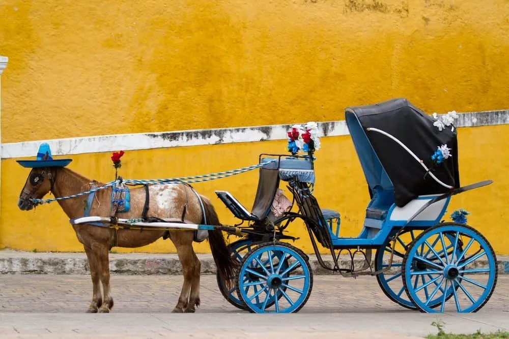 Izamal's golden-yellow streets during Holy Week with pilgrims visiting the Convento de San Antonio de Padua