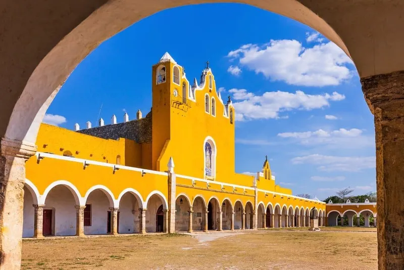 Yellow buildings around Izamal's central streets glowing in late-afternoon Yucatán light