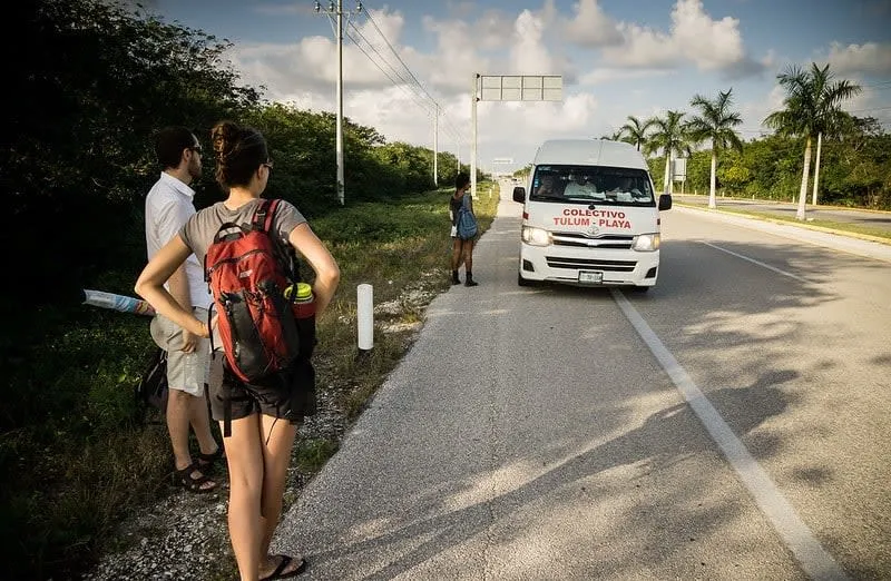 White colectivo van parked along the Tulum route toward the lagoon entrance