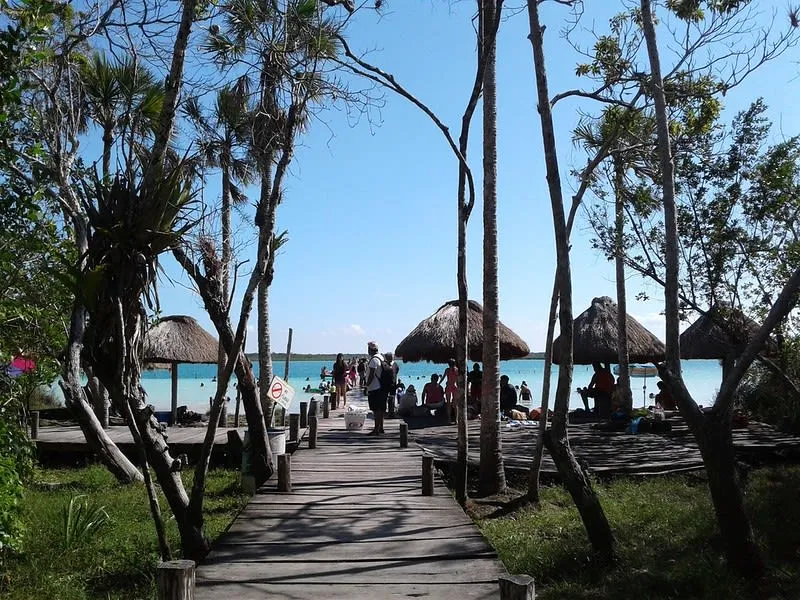 Rustic lagoon entrance area with palapa shade and visitor facilities