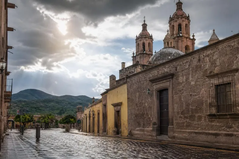 Church towers above wet colonial streets in Lagos de Moreno after August rain