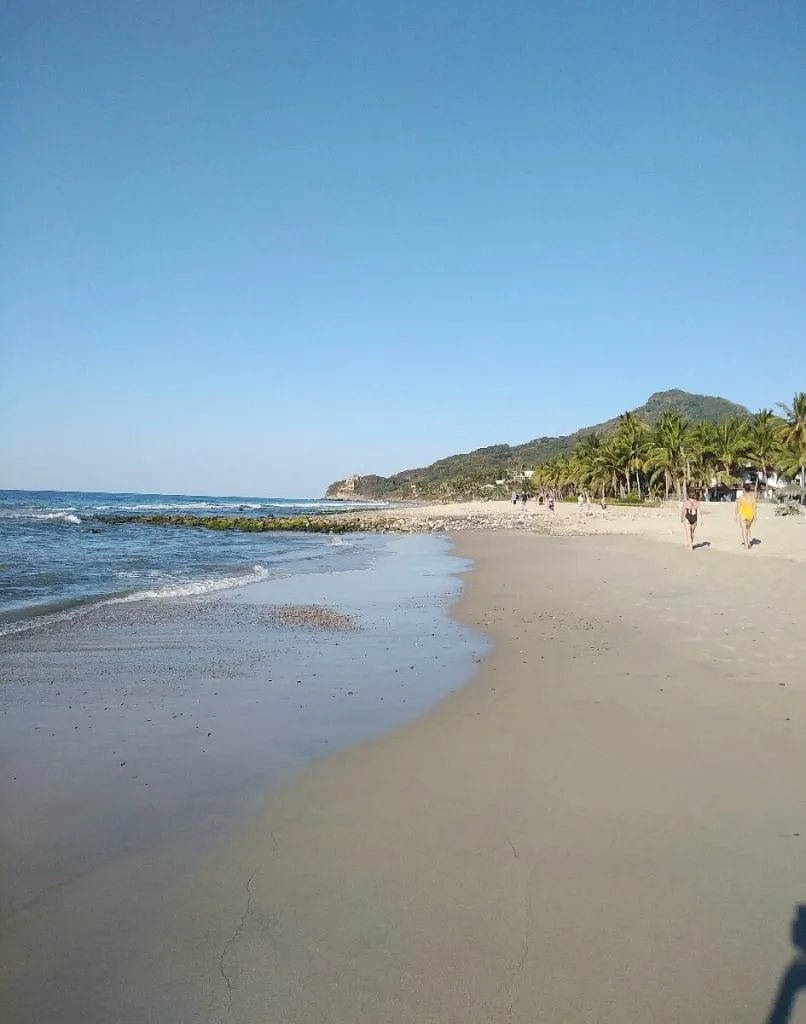 Litibu Beach with golden sand, turquoise water, and undeveloped coastline