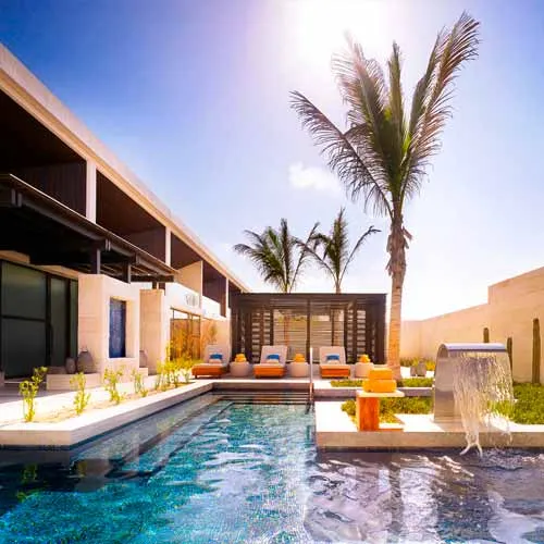 Minimalist Nobu Los Cabos wellness space with pale stone walls and calm spa seating