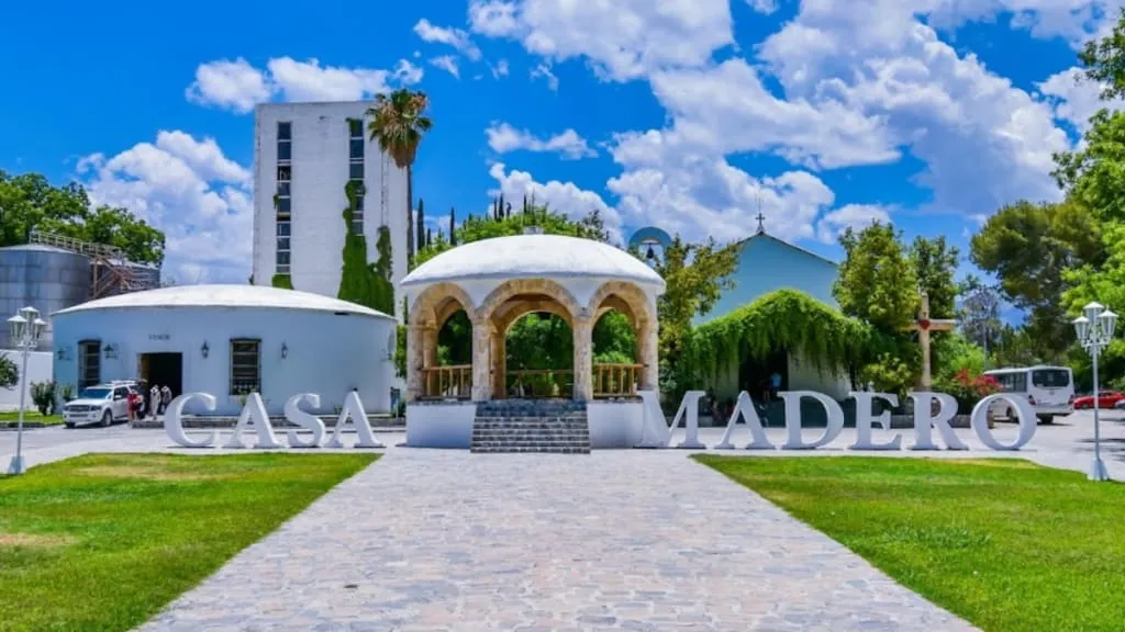 Casa Madero winery estate with vineyards and desert hills behind it