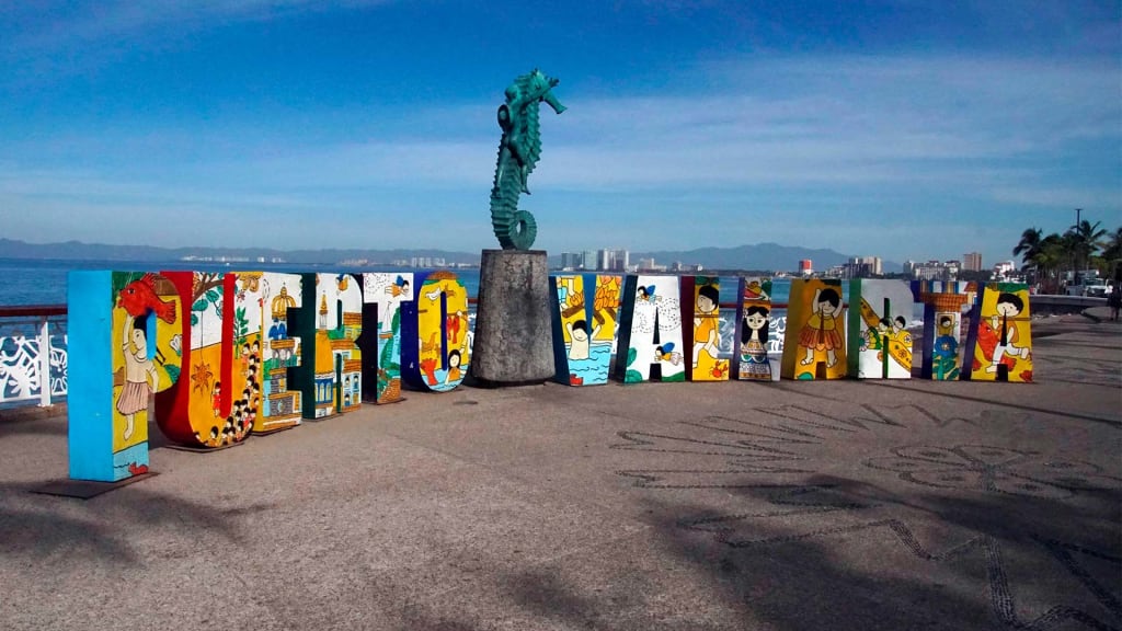 Puerto Vallarta Malecón boardwalk along Banderas Bay — 30-minute drive from PVR airport through the Hotel Zone