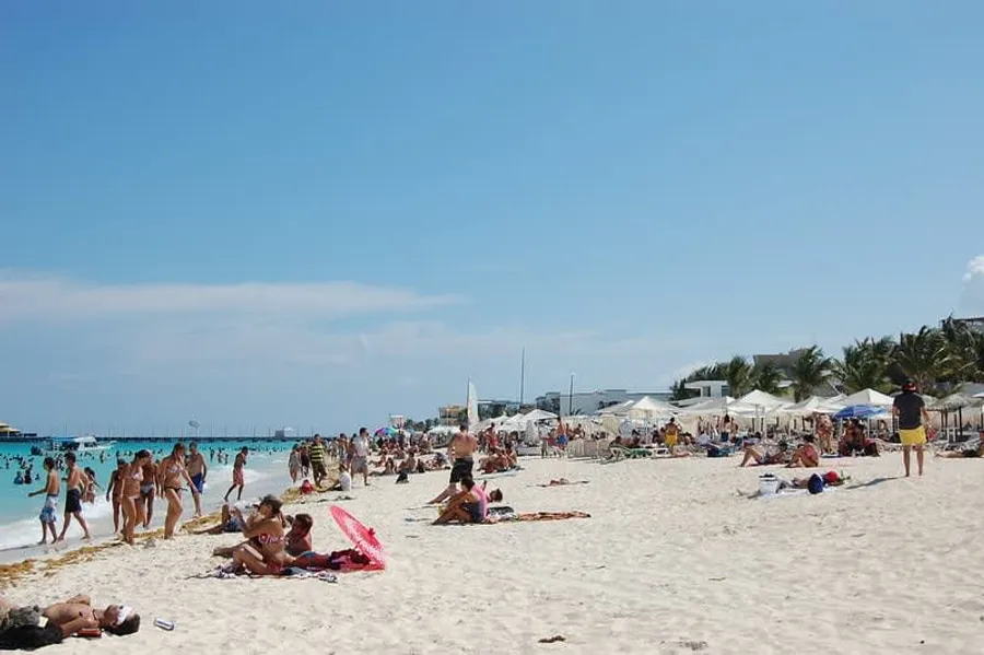 Mamitas Beach Club in Playa del Carmen during Semana Santa with packed sunbeds and Caribbean backdrop