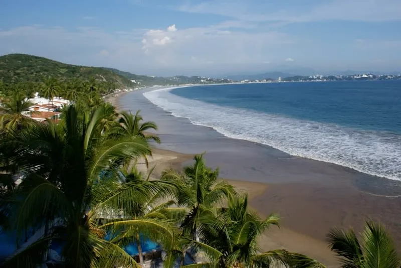 La Boquita beach area in Manzanillo with palapas and Pacific water in summer