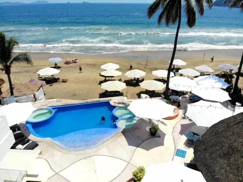 Beachfront Manzanillo hotel with shaded pool area for humid August afternoons