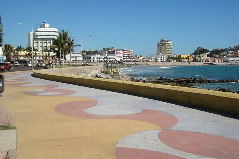Mazatlan shoreline with tall beachfront towers beside calm Pacific water