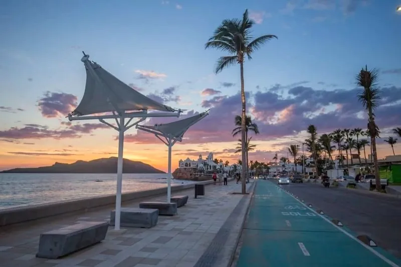 Mazatlan shoreline with palapa umbrellas, Pacific surf, and a bright summer sky
