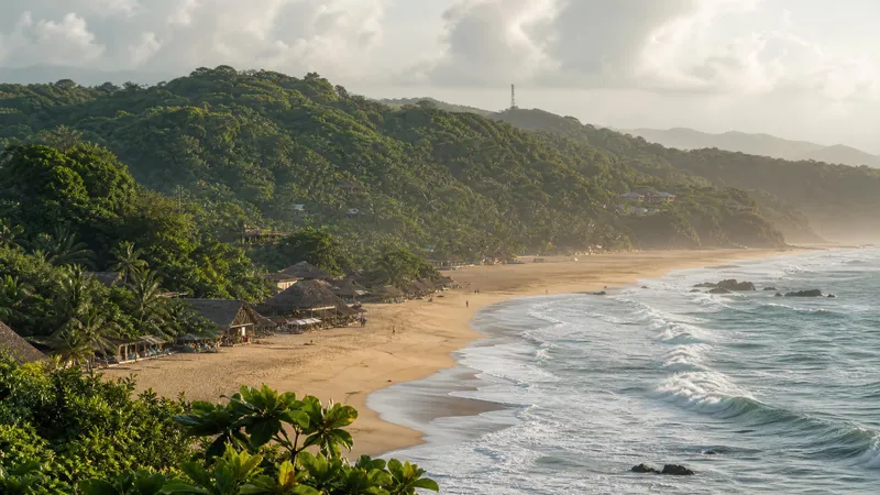 Mazunte beach and green Oaxaca Coast hills during humid August rainy-season weather