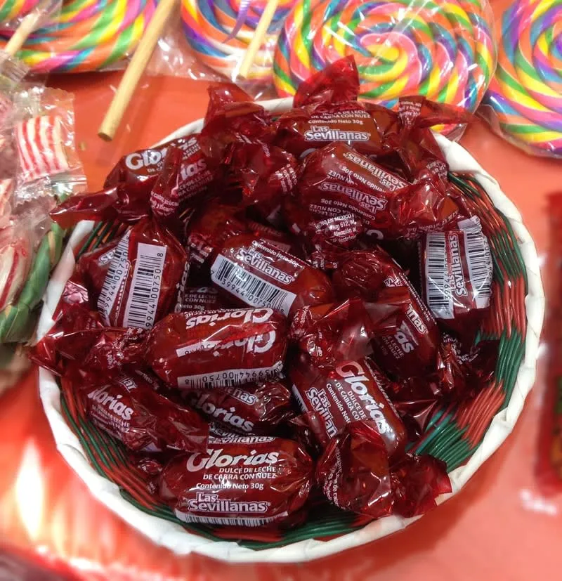 Wrapped Glorias milk candies from Linares with red cellophane ends