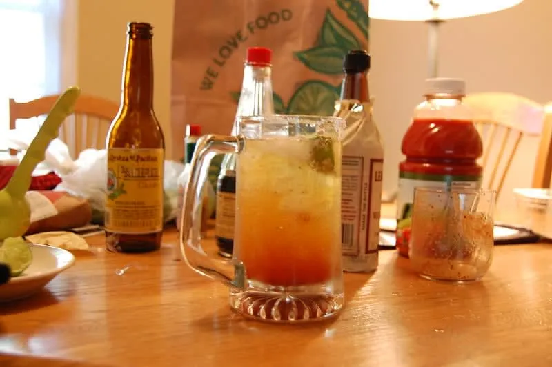 Michelada Mexican beer cocktail with lime juice, Worcestershire sauce, chili salt rim and Clamato