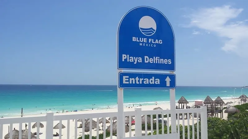 Wide Playa Delfines shoreline with Cancun Hotel Zone water in bright blue shades