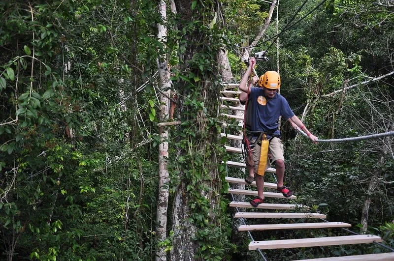 Selvatica cenote near Puerto Morelos — zip line over cenote with jungle canopy background
