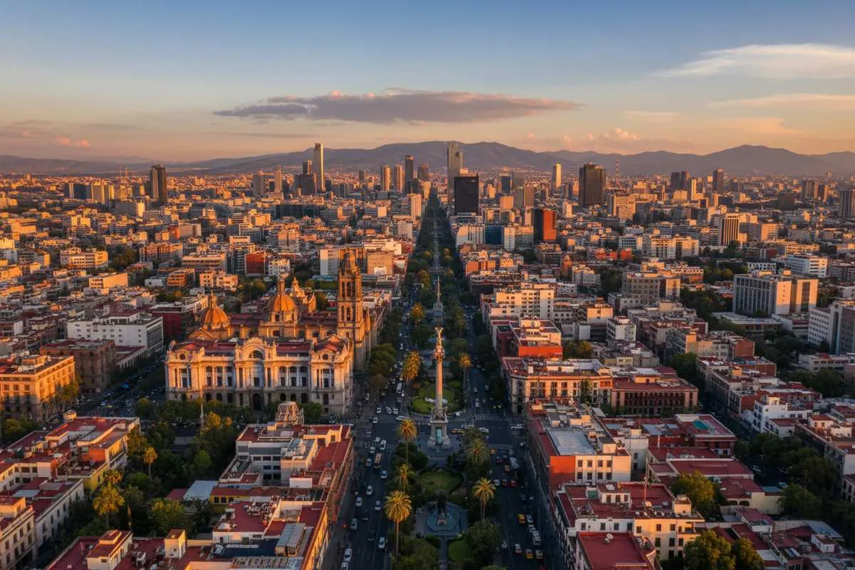 Tourists exploring Mexico City's Centro Histórico with the Metropolitan Cathedral and Zócalo visible in the background during golden hour