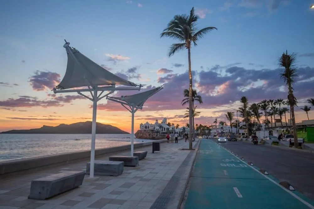 Mazatlan Pacific coast malecon promenade stretching along the ocean in Sinaloa Mexico with mountain backdrop