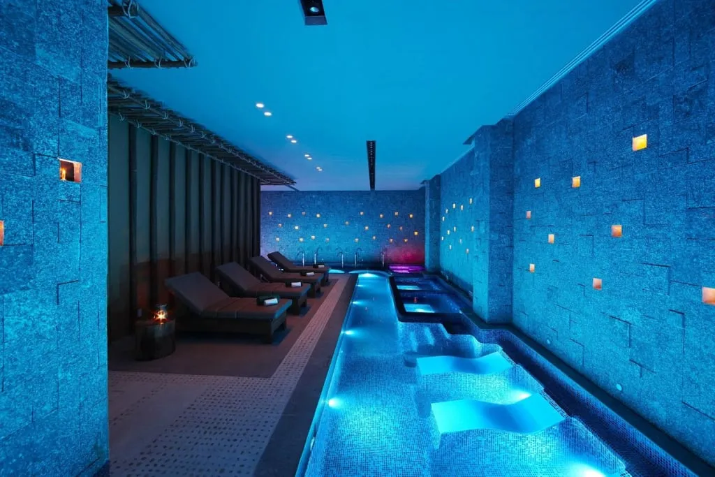 Banyan Tree Mayakoba spa pavilion beside Riviera Maya lagoon water and tropical plants