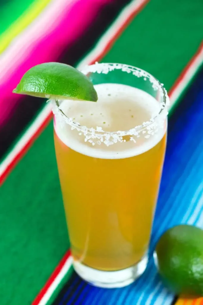 Classic chelada with beer, lime juice, and a salted rim