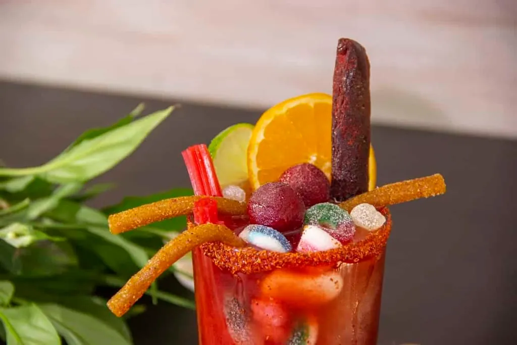 Gomichela with chamoy, tamarind candy, and gummy skewers