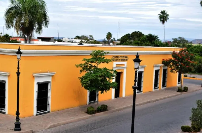 Painted 19th-century Cultural Center building on a Mocorito corner