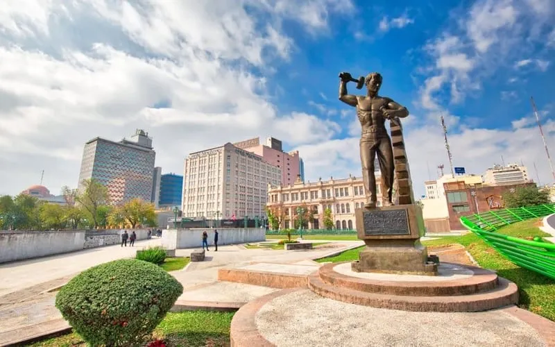 Macroplaza in Monterrey in August with city-center sightseeing, hotel-base planning, and hot weather