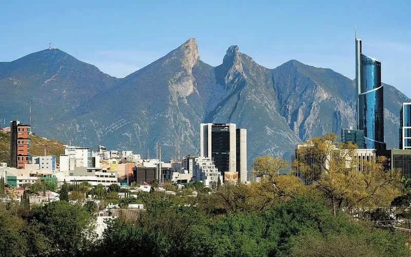 Monterrey skyline and Cerro de la Silla in August with hot weather and summer storm planning