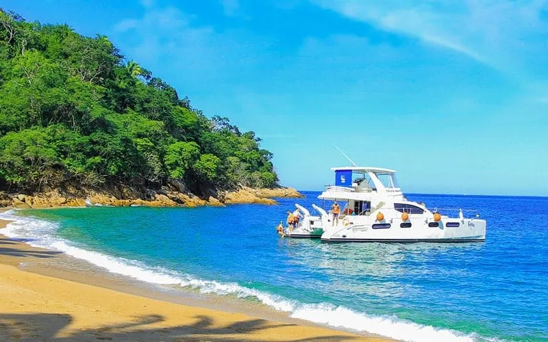 Las Caletas cove with forested cliffs and beach day-trip facilities