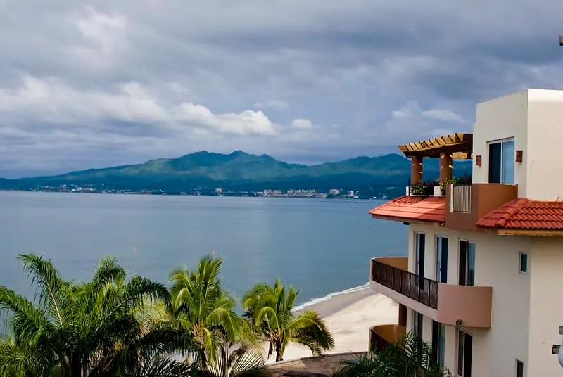Wide Nuevo Vallarta beach with palapas and calm Pacific water