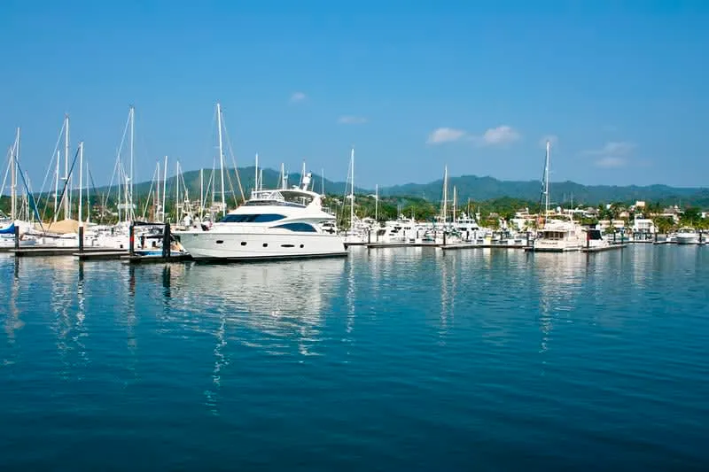La Cruz de Huanacaxtle marina with fishing boats and yacht masts reflected in calm water, Riviera Nayarit Mexico
