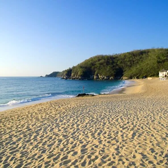 Oaxaca Pacific coast beach — a pristine Pacific beach in Oaxaca state with dramatic headlands and deep blue water