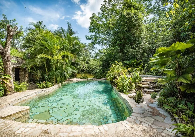 Palenque hotel area in August with pool, shade, and A/C-first rainy-season planning