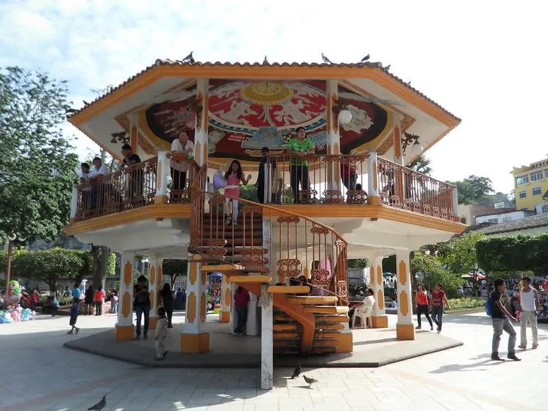 Ornate white kiosk standing in a leafy Veracruz town square