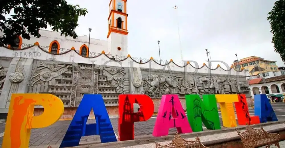 Central plaza with tiled walkways and trees in downtown Papantla