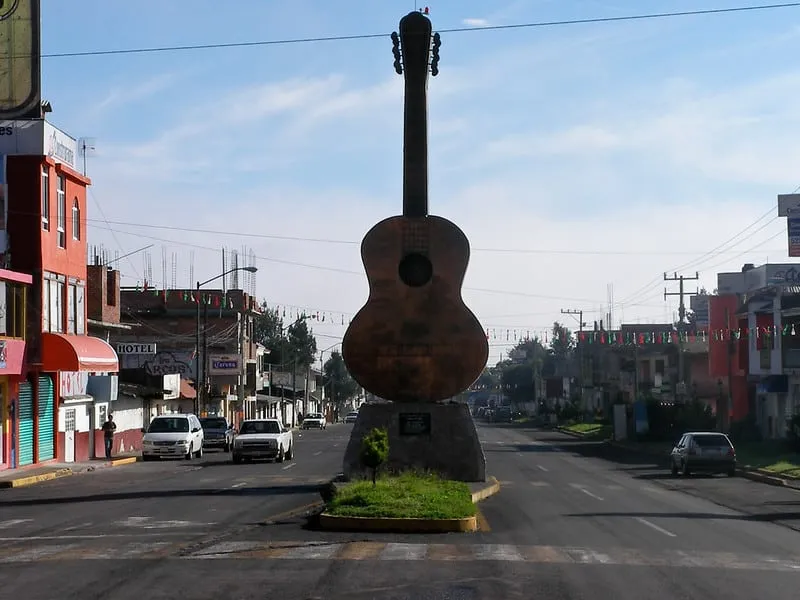 Handcrafted classical guitars displayed in a Paracho luthier workshop — Michoacán's guitar-making capital where over 800 craftsmen build 80% of Mexico's acoustic guitars