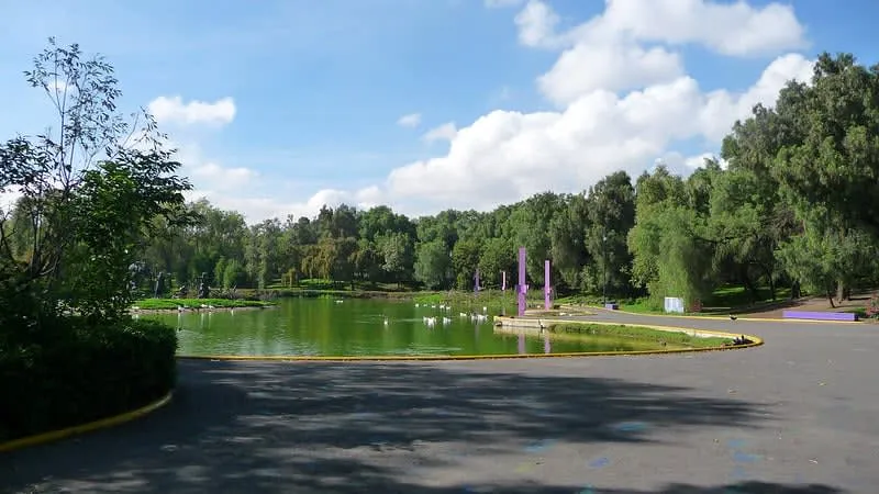 Tezozómoc Park lake with paths and pre-Hispanic landscape mounds