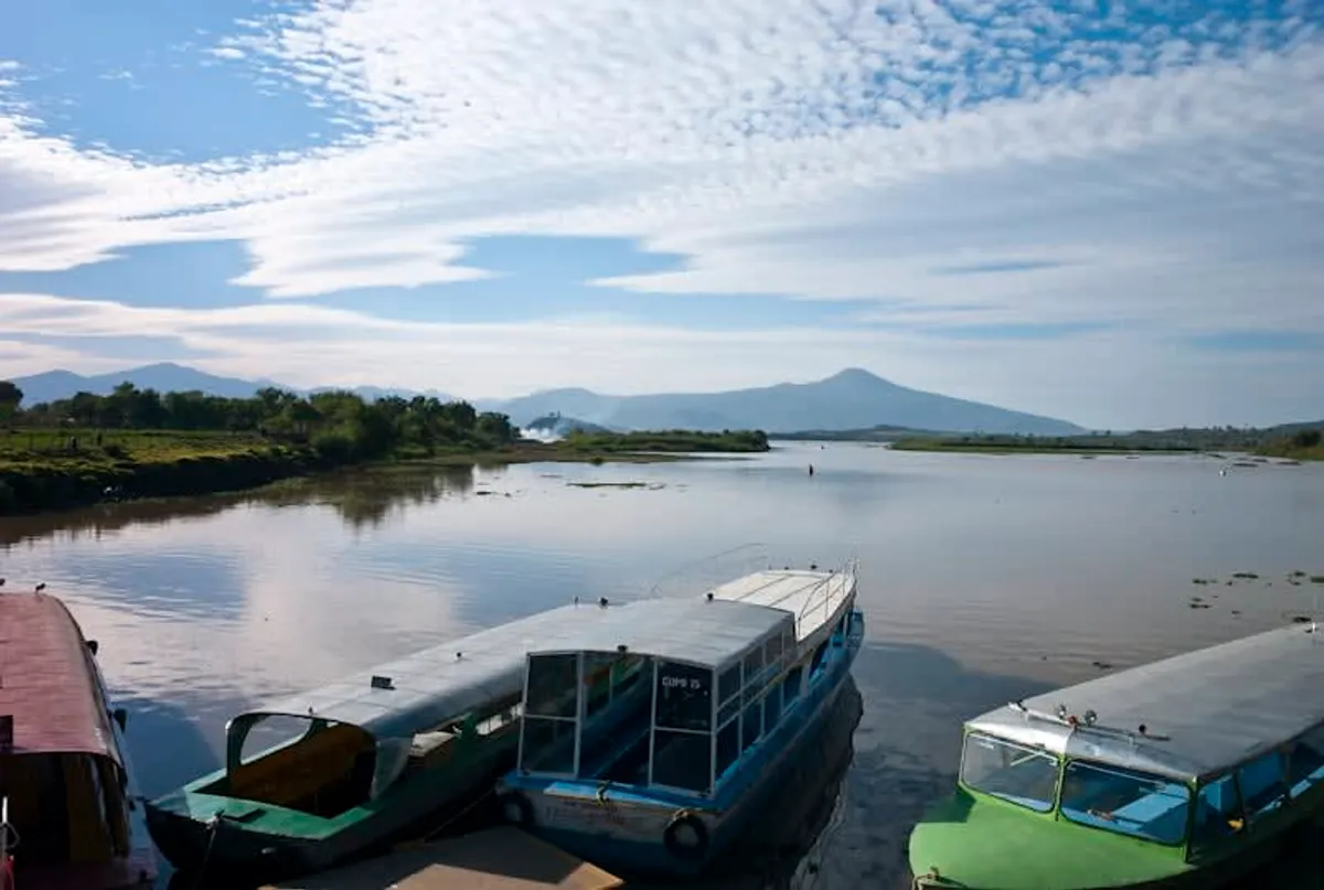 Lake Pátzcuaro at dusk with fishing boats and the silhouette of Janitzio island