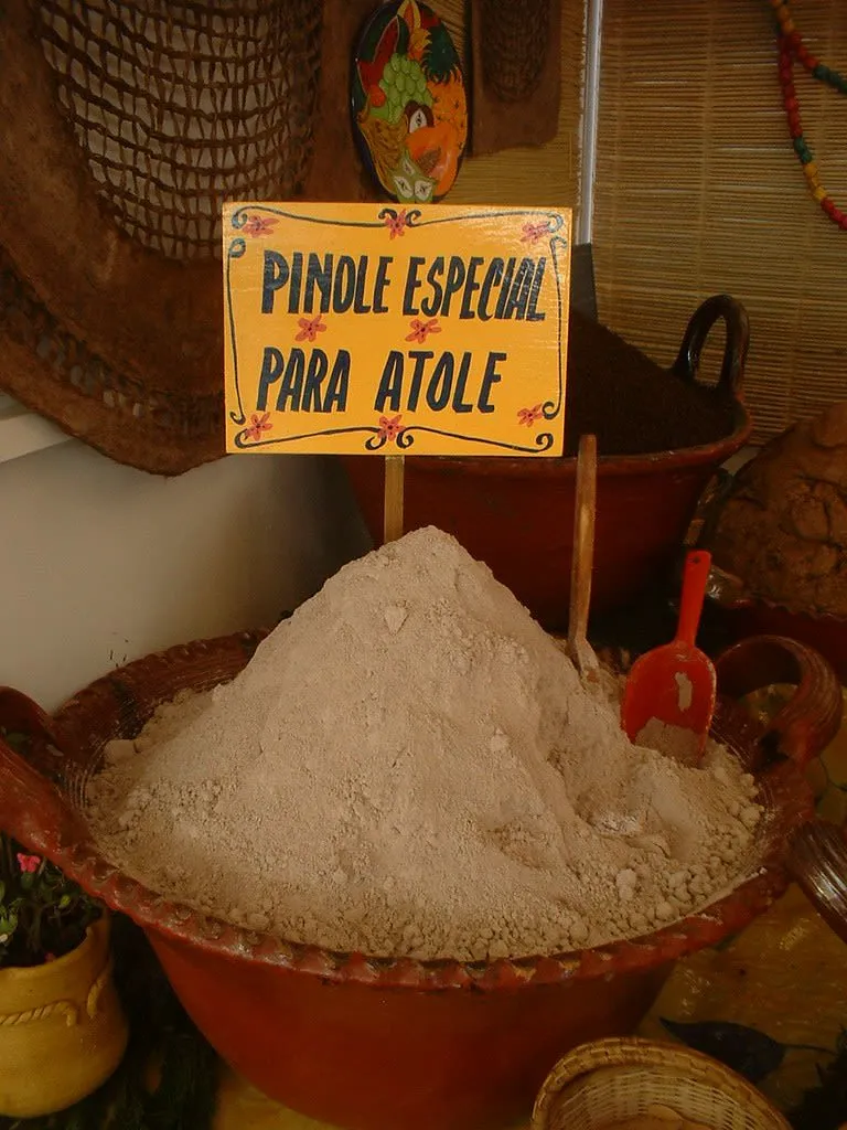Glass mug of creamy corn drink dusted with cinnamon