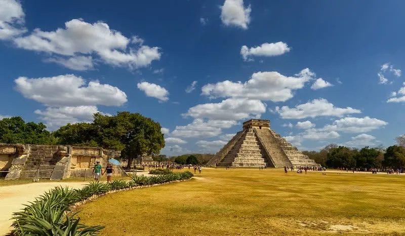 Ancient Maya pyramid rising above jungle canopy at an archaeological site in the Yucatan Peninsula near Playa del Carmen