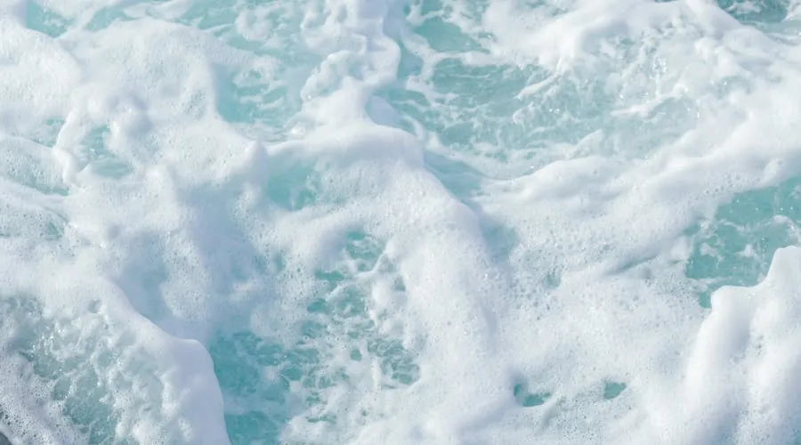 Cozumel coral reef with colorful tropical fish and crystal clear Caribbean water, viewed from ferry boat approaching the island from Playa del Carmen
